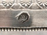 an image of a close up of a silver plate with a bird on it