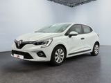a white car in a white room with a black floor