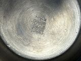 a metal bowl with a design on it