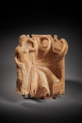 a roman marble relief of a seated woman