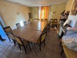 a table and chairs in a room with a large window