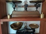 a wooden shelf with two scales on top of it