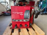 a red machine that is sitting on a pallet
