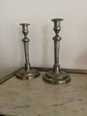 two candles sitting on a tray on a table
