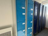 several blue lockers are lined up in a row in a room