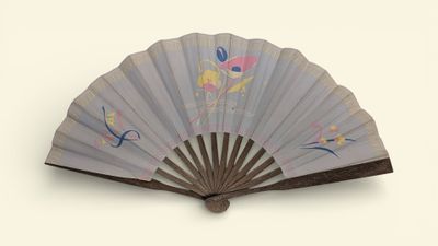 a fan with a design on it on a white surface