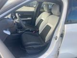 the interior of a car with the door open and the passenger seat down