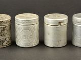 four different types of tins sitting next to each other on a table
