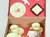 a suitcase with a set of dishes and utensils in it