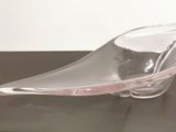 a glass bowl on a black table with a white background