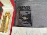 a gold lighter in a red box on a table