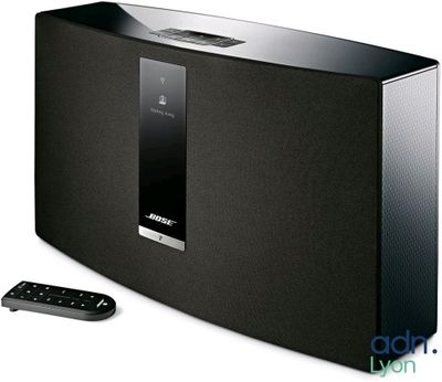 bose music system with remote and remote control in front of white background