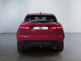 the rear end of a red car in a white room
