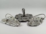 four pieces of silverware are sitting on a white surface