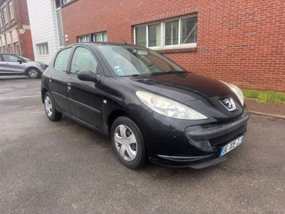a picture of a black car parked in front of a brick building