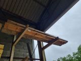a picture of a building that has a roof and a window