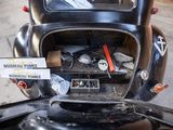 an old car with a bunch of items in the trunk