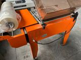 a machine that has a roll of tape on top of it