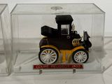 a small toy car in a clear box on a white surface