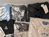 a lot of clothes that are sitting on a table
