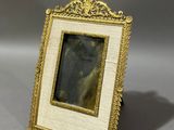 an old picture frame with a picture of a woman in it
