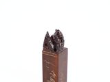 a wooden box with a statue of a man and a dog on it