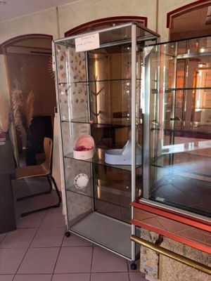 a glass display case in the middle of a room