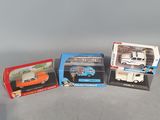 three boxed toy cars are sitting on a table next to each other
