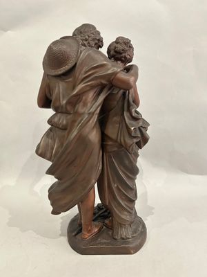 statue of a man and a woman hugging each other on a marble base