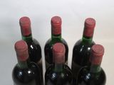 four bottles of wine are lined up on a table