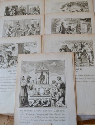 many old books on a table with pictures on them