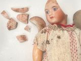 a small doll with a broken wing and a broken piece of wood