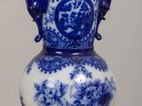 a blue and white vase sitting on a table