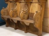 four wooden benches sitting next to each other in a room