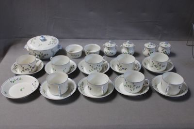 un grand nombre de tasses et de soucoupes sur une table