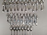 many forks and spoons laid out on a table