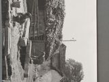 a black and white photo of a man working in a garden