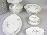 a lot of plates and bowls that are on a table