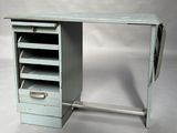 a small desk with drawers and a mirror on it