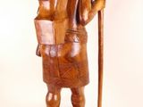 wooden statue of a man with a hat and a cane