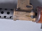a close up of a machine gun with a wooden handle