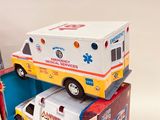 several toy ambulances are stacked on top of each other