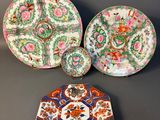 three chinese plates and a small plate on a table