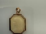 a close up of a pendant with a picture of a woman on it