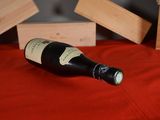 a bottle of wine sitting on a red table cloth