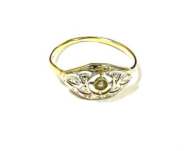 an image of a close up of a gold ring with a pearl
