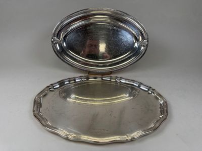 a silver plate with a mirror in the middle of it