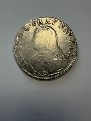 a close up of a coin on a white surface