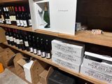 many bottles of wine and boxes of wine on the shelves