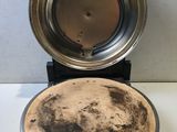a dirty pan sitting on top of a stove